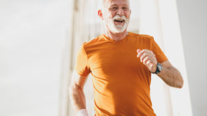 An older man enjoying a run outdoors.